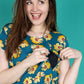 Stylish Breastfeeding Dress showing access via a zip. The dress has a sunflower print. 