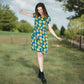 Woman in a floral breastfeeding dress standing in a grassy field with trees in the background